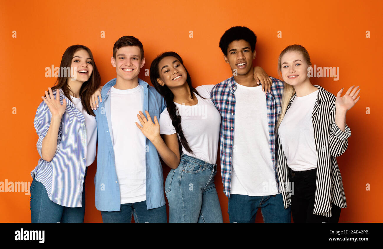 Teen friends saying hello and waving hands to camera Stock Photo Alamy