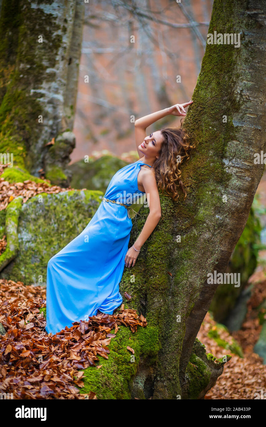 Beautiful woman in blue dress in the forest in autumn day Stock Photo ...