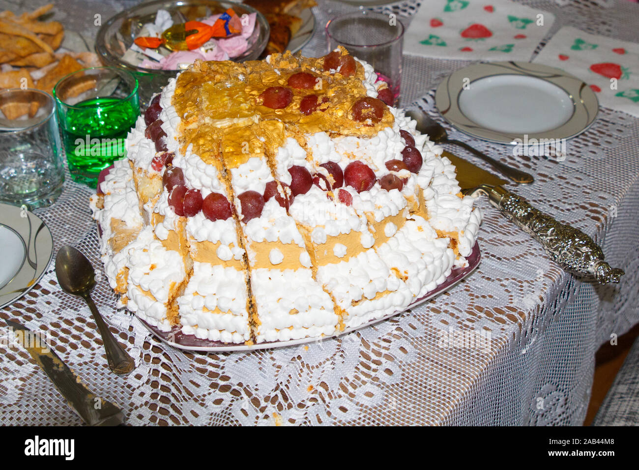 Birthday party cake with fruit on table. Cut cake. Stock Photo