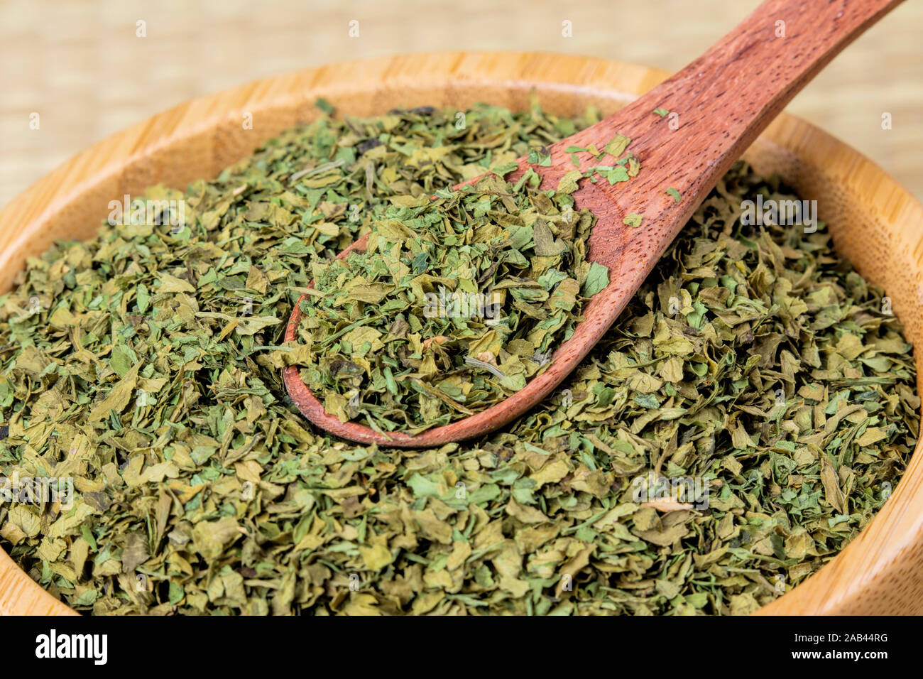 Wooden bowl fulled with delicious diced Parsley, a very popular garnish Stock Photo