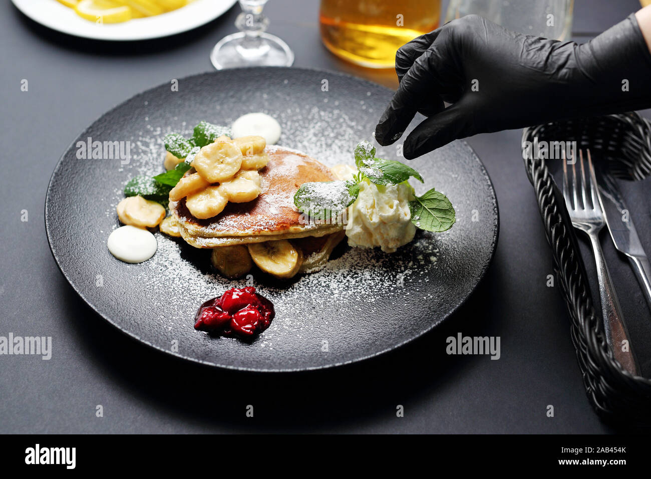 Cooking. The chef decorates the plate. Serving and decorating the dish. Stock Photo