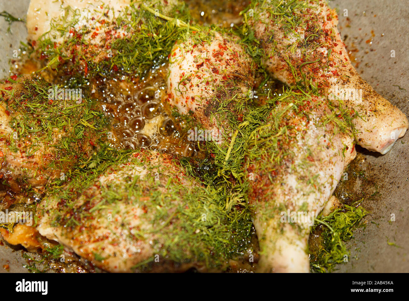 Cooking fried chicken legs with dill in metal pan Stock Photo Alamy