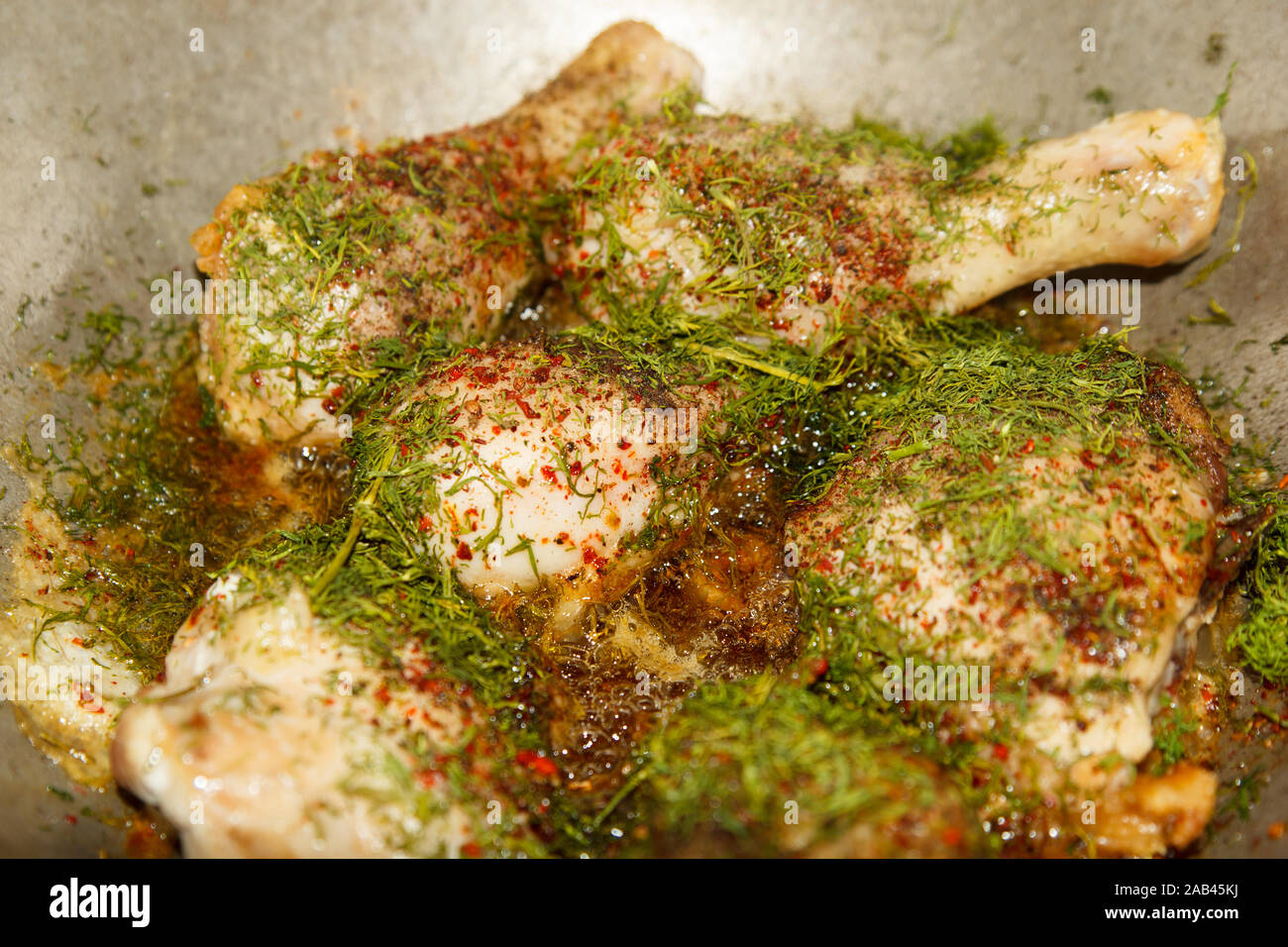 Cooking fried chicken legs with dill in metal pan Stock Photo Alamy