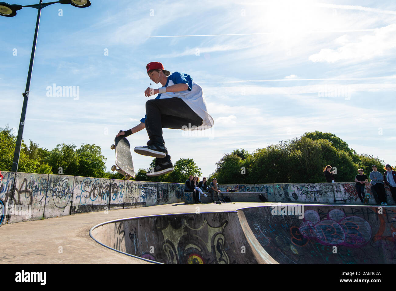 professional-skateboarders-skating-out-of-a-concrete-bowl-and-doing-a