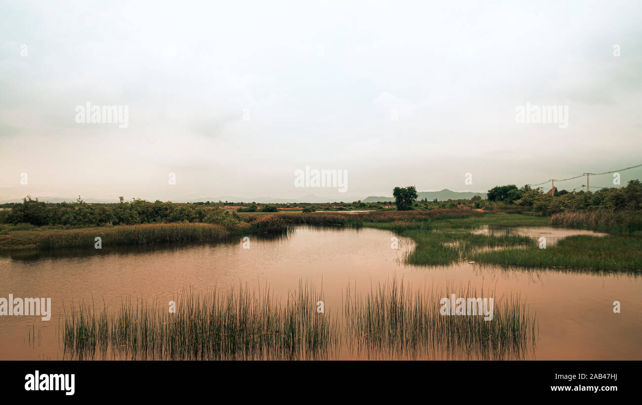 Beautiful landscape with a  calm evening landscape with lake and mountains in Prachubkeereekhan Thailand Stock Photo