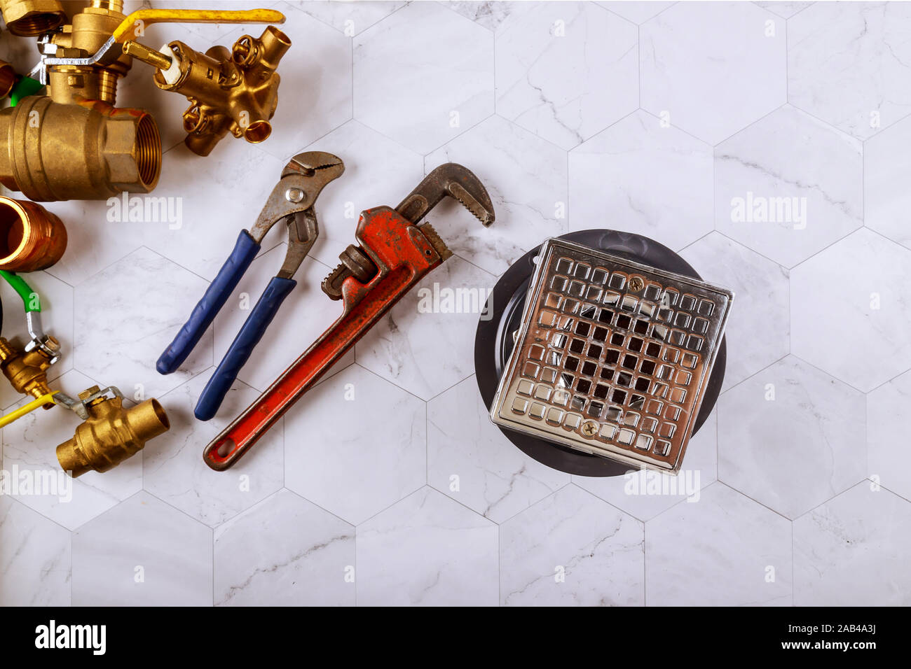 Closeup of a drain in shower room monkey wrench in the plumbers fixtures Stock Photo