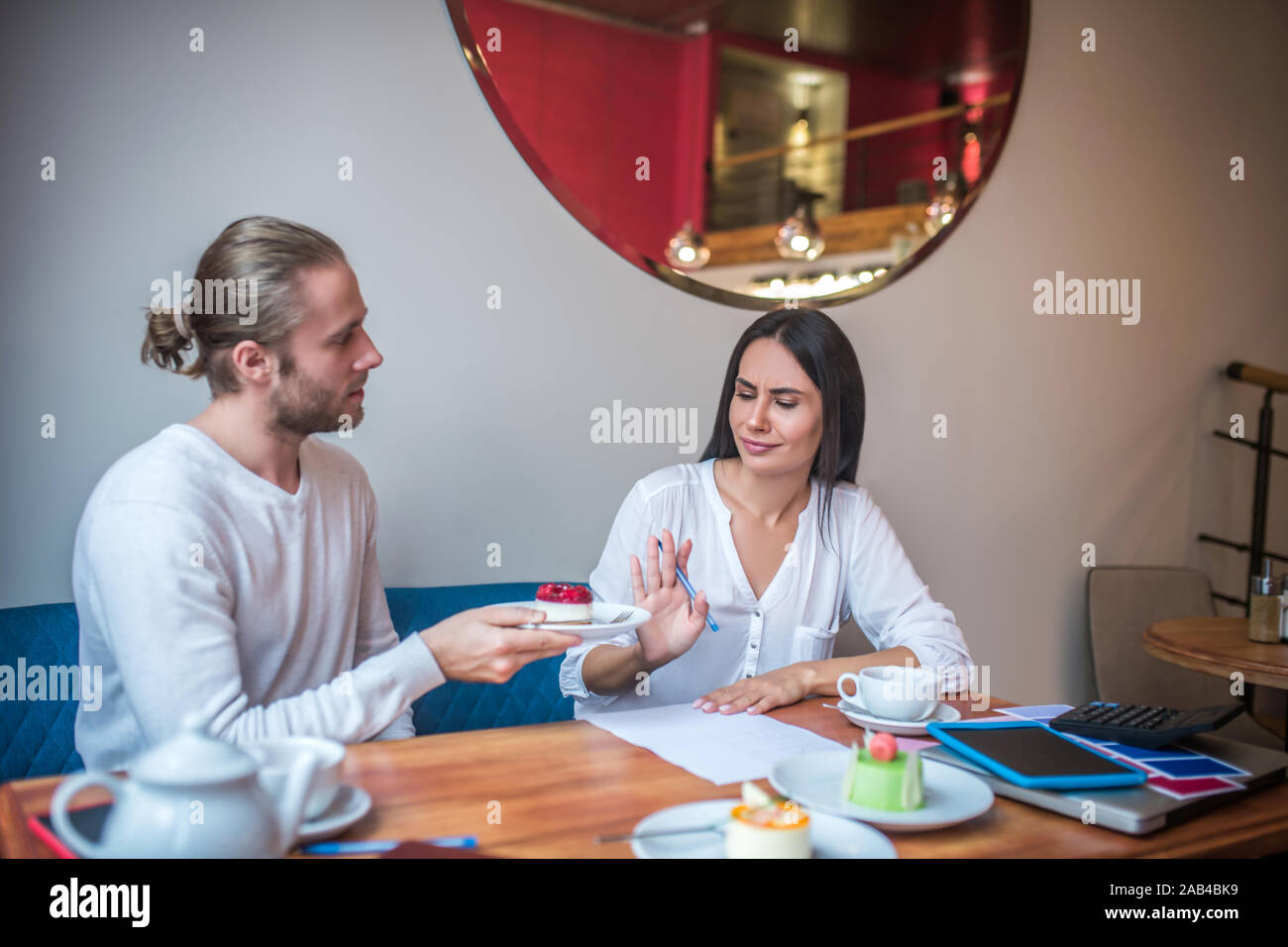 Wife feeling not satisfied with dessert while composing menu Stock Photo