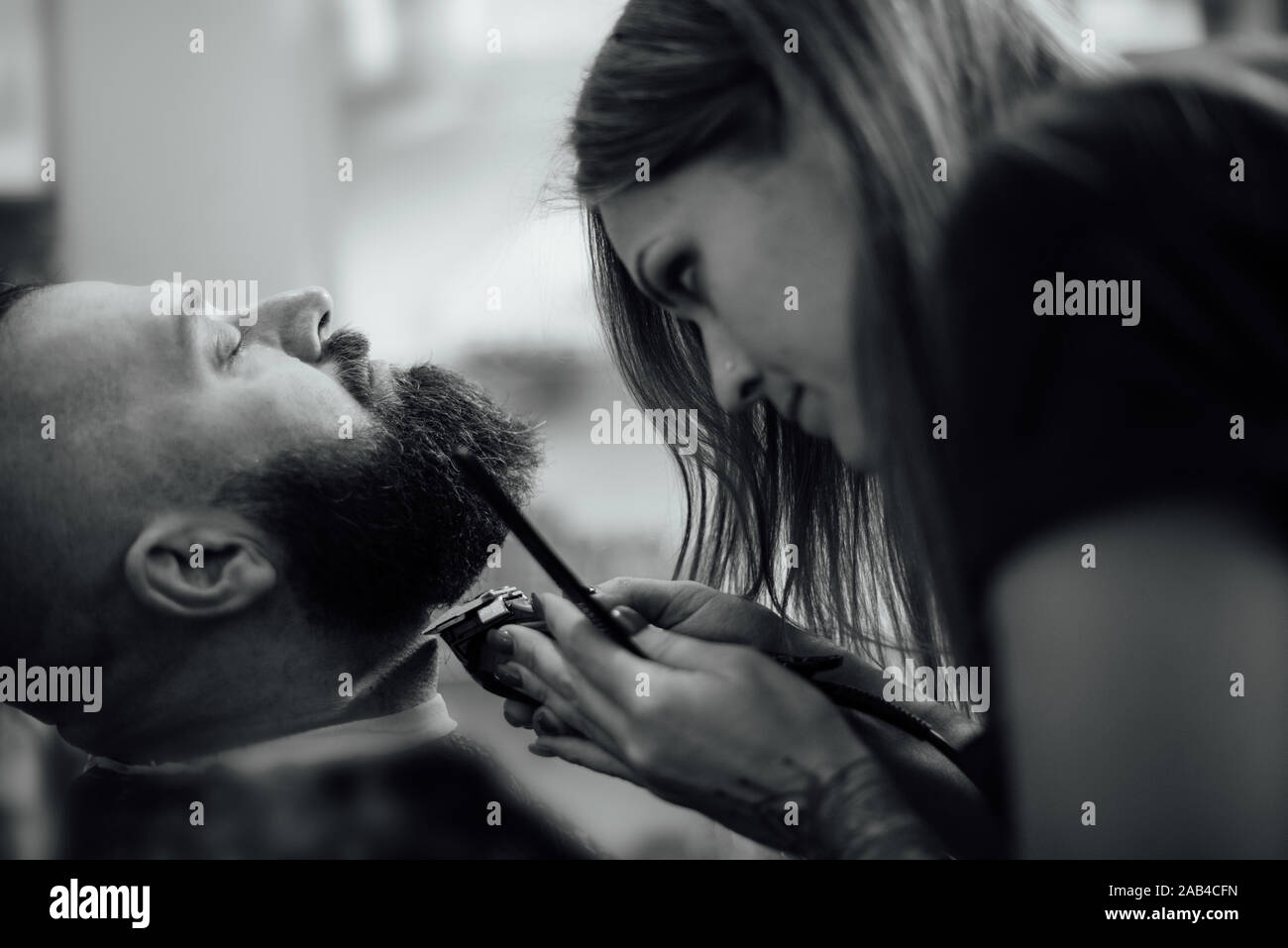 Male Hipster In Barbershop Barber On Fashionable Haircut A Man