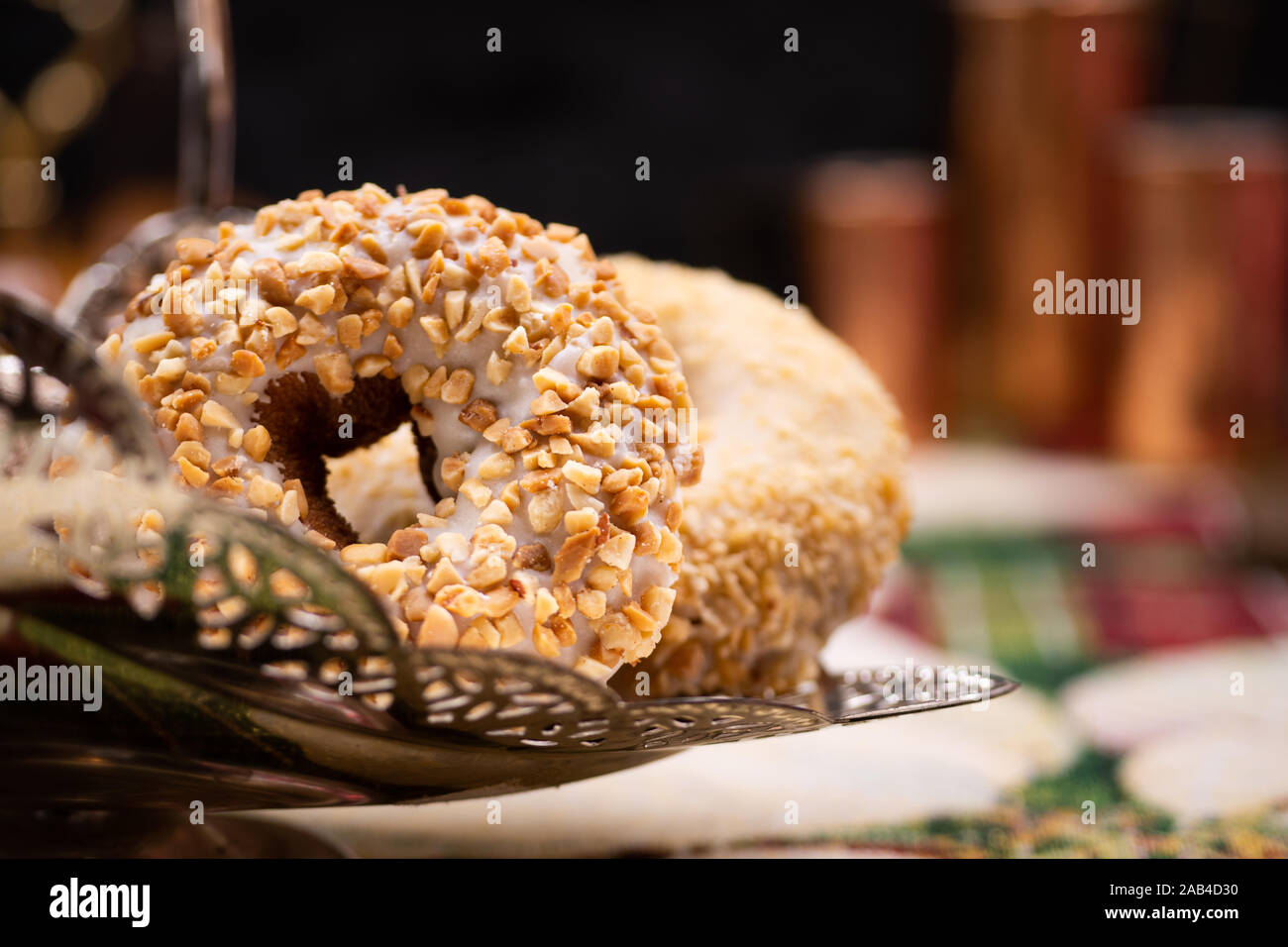 Doughnuts and doughnut holes on silver dessert stand Stock Photo