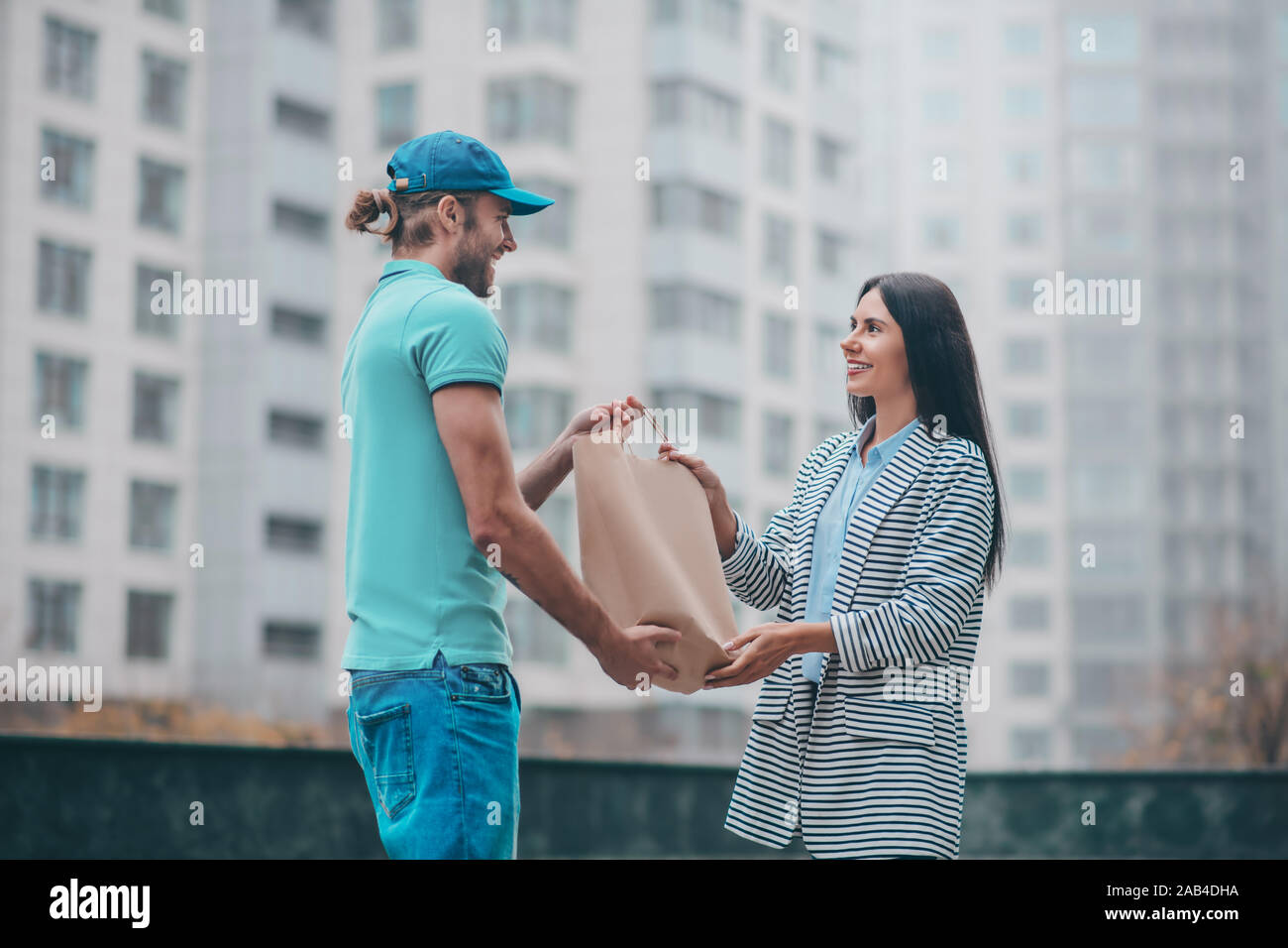 Handsome smiling delivery man hi-res stock photography and images - Alamy
