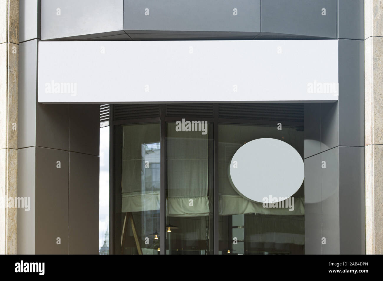 Blank white rectangular and round sign on business center mockup Stock Photo