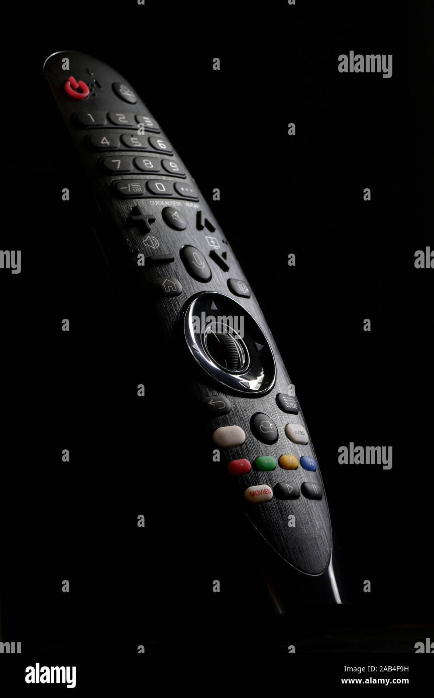 Tv Remote Control And Shadows on Black Background Stock Photo
