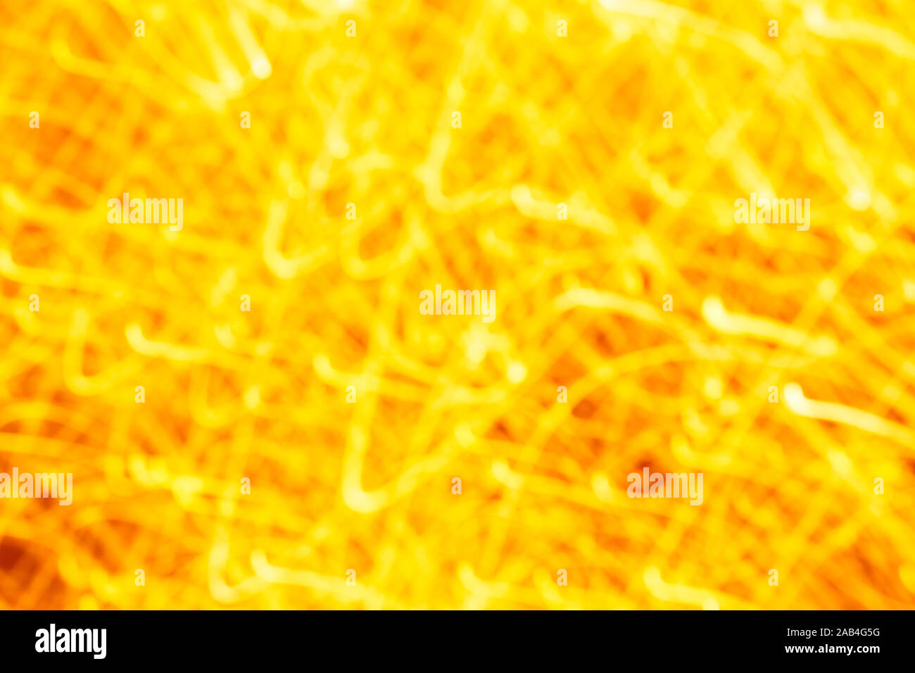 Futuristic blurred lights holiday monochrome background in yellow. Horizontal, soft focus Stock Photo