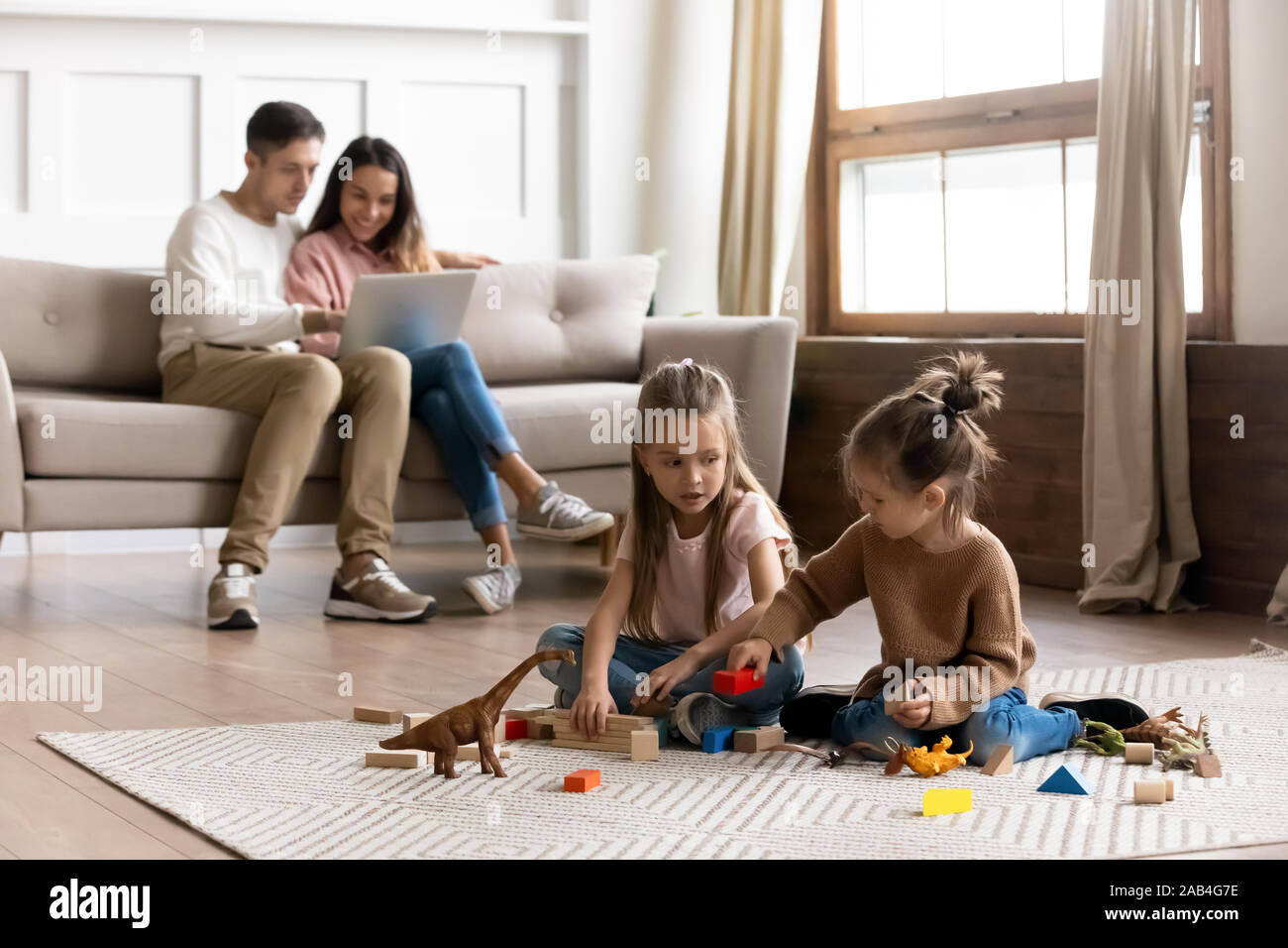 Happy family with cute kids daughters relax in living room Stock Photo