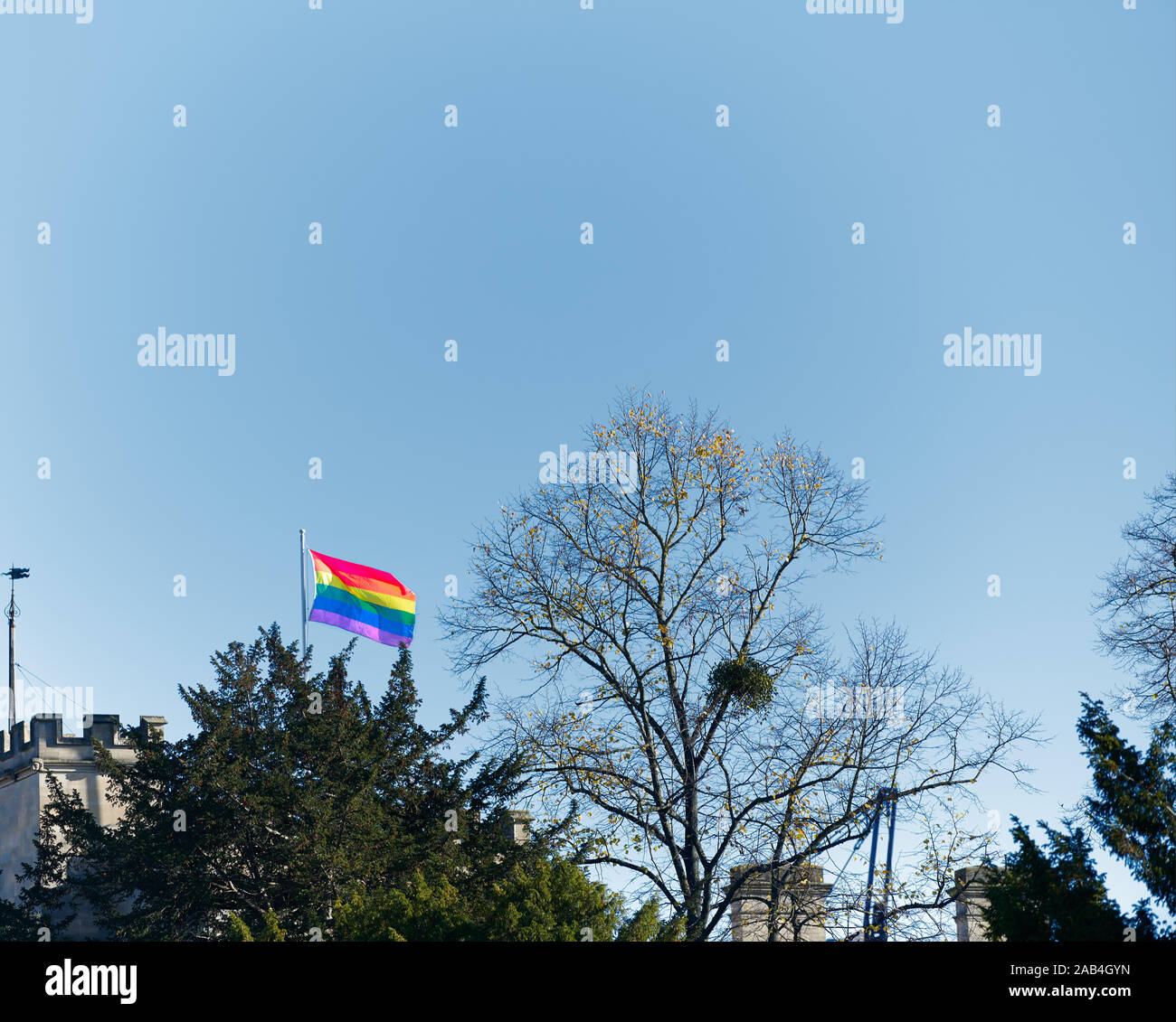 LGBT rainbow flag flying above Wadahm college at the university of Oxford, England, on a sunny winter day. Stock Photo