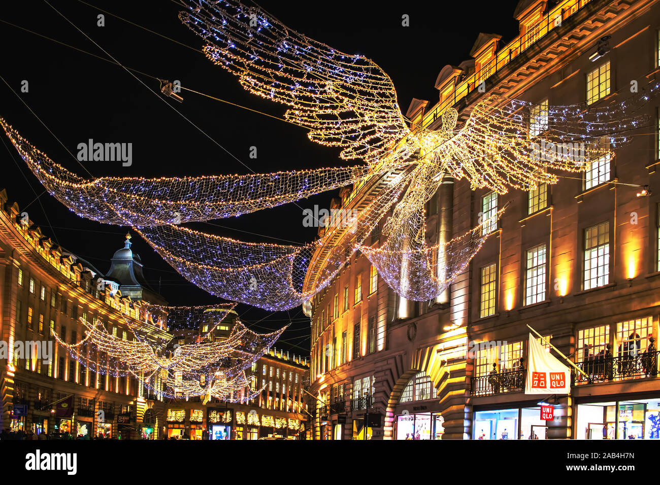 Angel Christmas lights flying above the shops and department stores of Regent Street in London, England Stock Photo