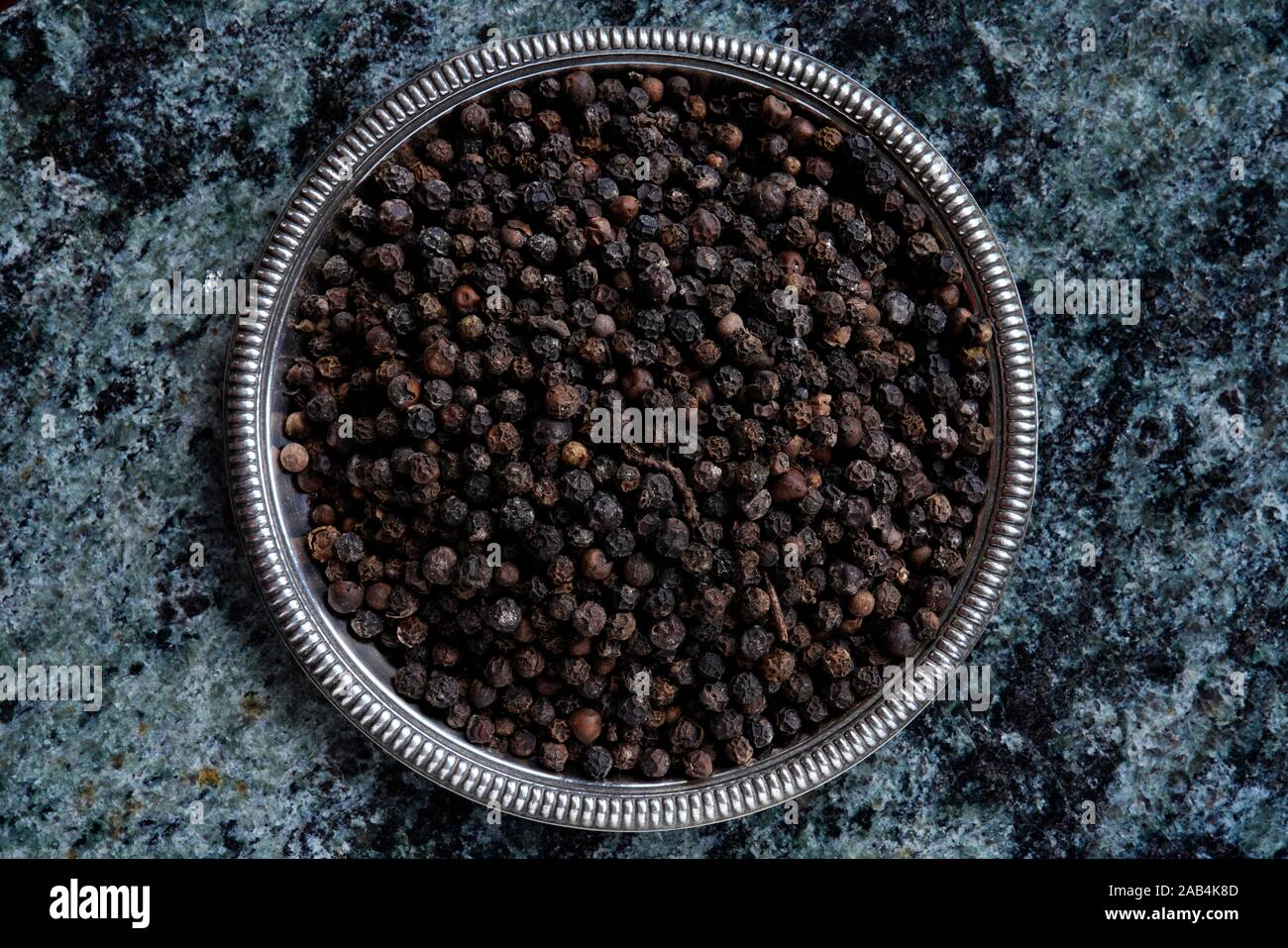 Black pepper, peppercorns in a bowl, India Stock Photo Alamy