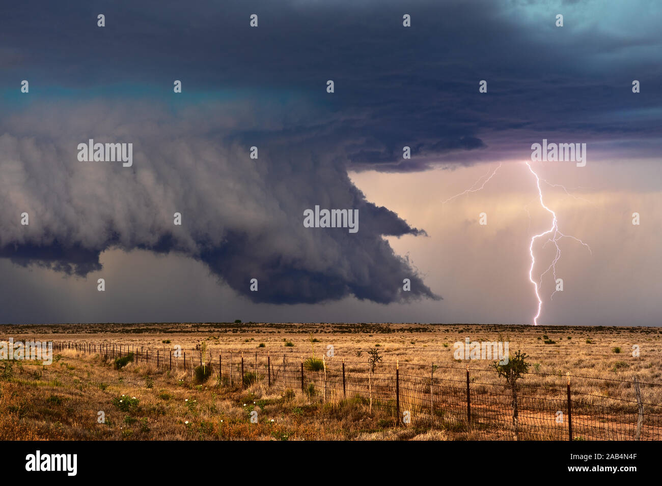 Dramatic lightning strike and ominous storm clouds from an approaching supercell thunderstorm near Roswell, New Mexico Stock Photo