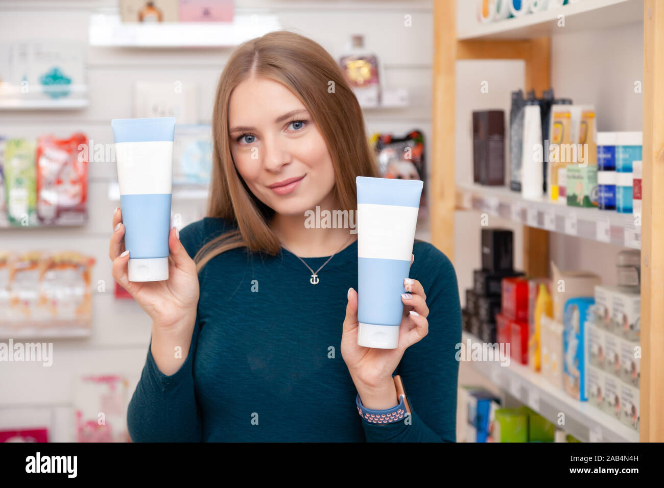 Beautiful caucasian girl cosmetologist hold box, tubes with cosmetic  product with no brand, mock up with blank label to add branding to product,  you c Stock Photo - Alamy