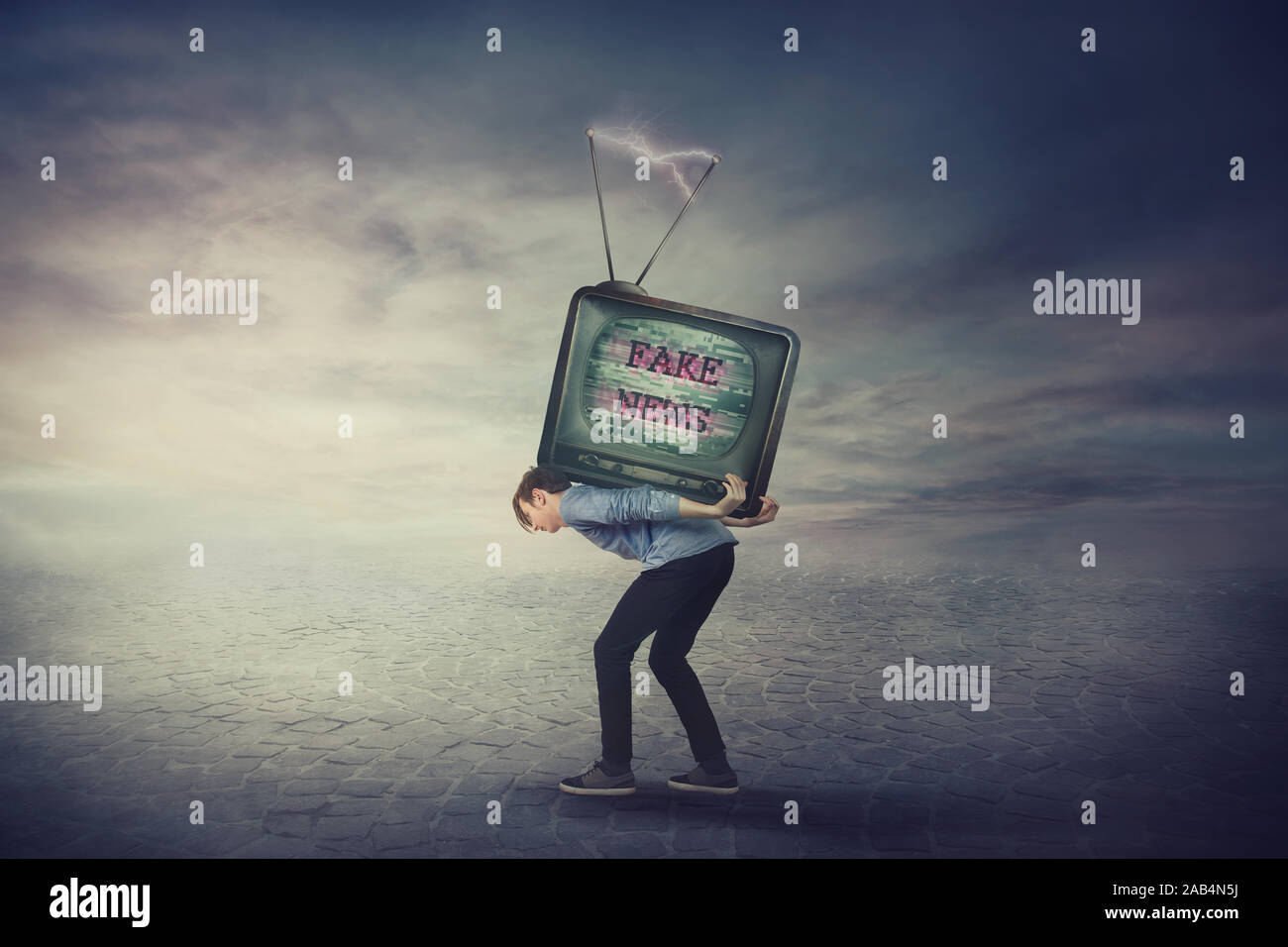 Bent down guy carrying an old TV box on his back. Overloaded man bored of daily fake news on television has a difficult burden. Mass media manipulatio Stock Photo