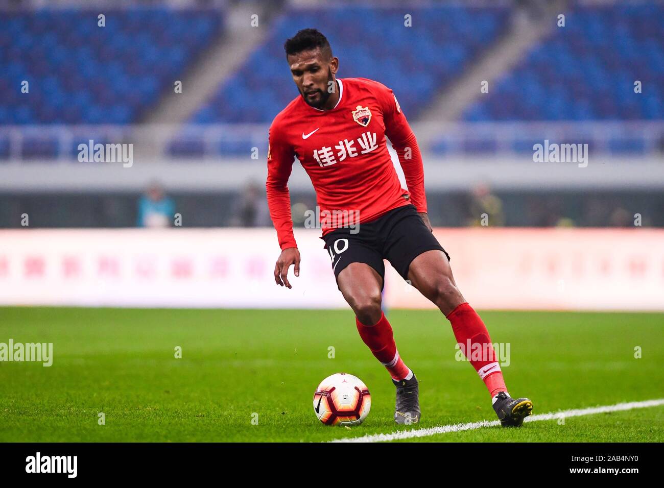 Brazilian-born Portuguese football player Dyego Sousa of Shenzhen F.C. keeps the ball during the 28th round match of Chinese Football Association Super League (CSL) against Tianjin TEDA in Tianjin, China, 23 November 2019. Tianjin TEDA slashed Shenzhen F.C. with 3-0. Stock Photo