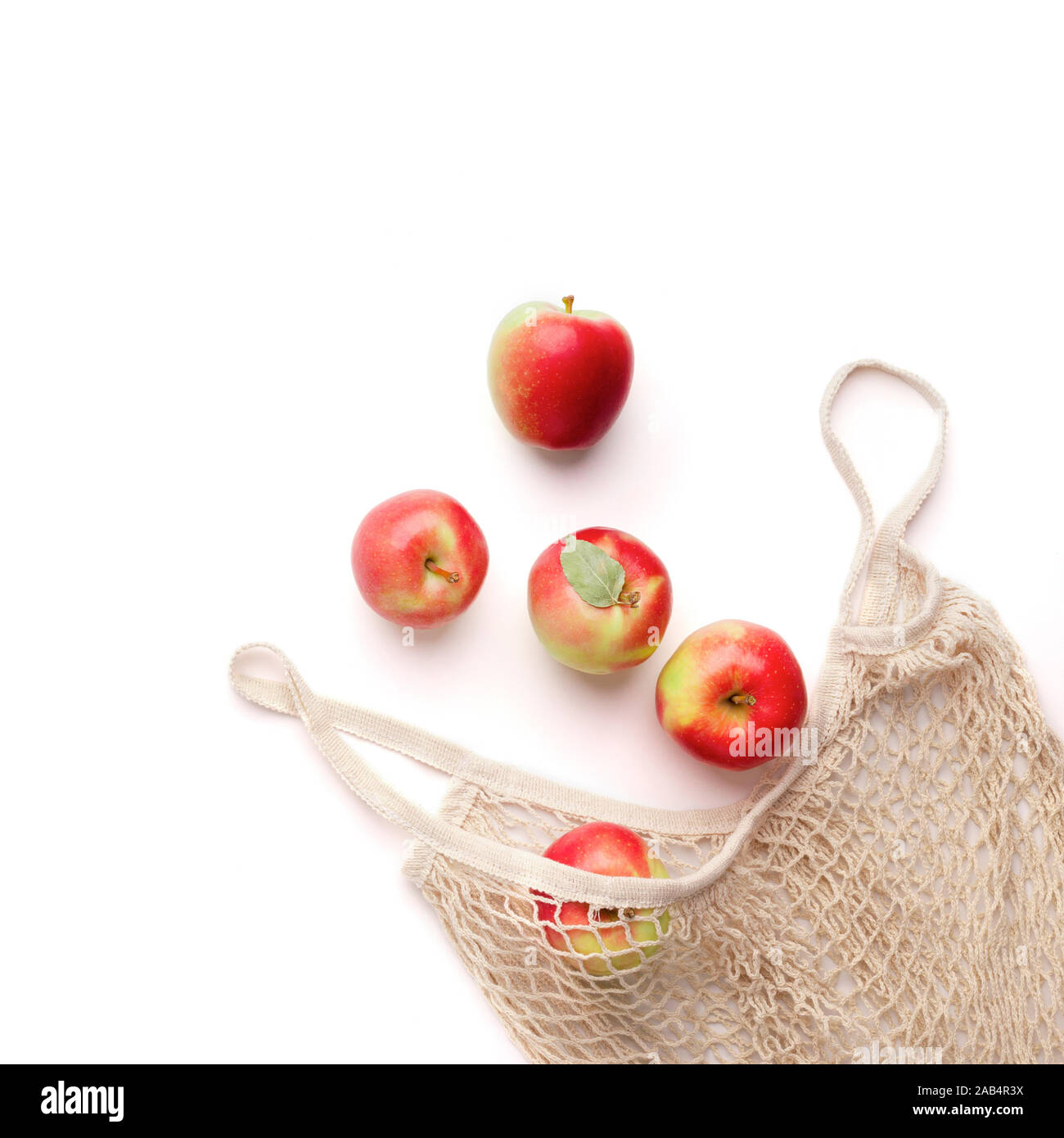 Fresh red apples in zero waste net bag on white background Stock Photo