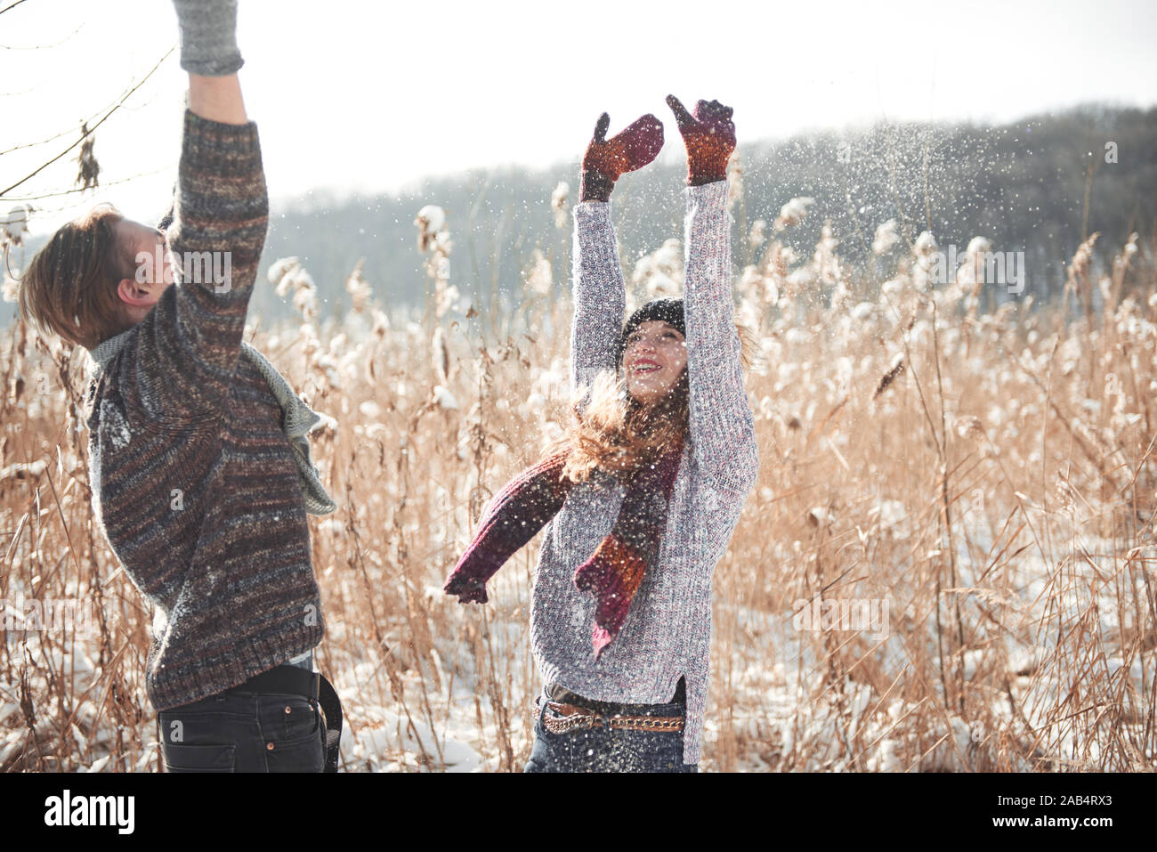 people, season, love and leisure concept - happy couple having fun over winter background Stock Photo