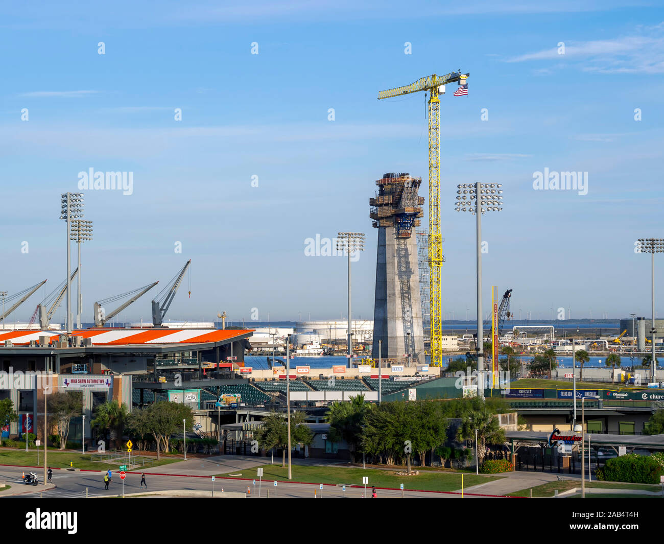 Elevated view the Whataburger Field baseball venue in Corpus Christi, Texas USA with New Harbor Bridge support column under construction in background. Stock Photo