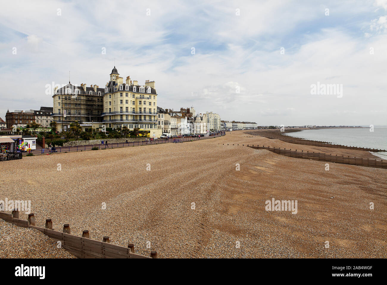 Seafront hotels and multiple groynes on Eastbourne beach, viewed here on an overcast day in May 2019. Stock Photo