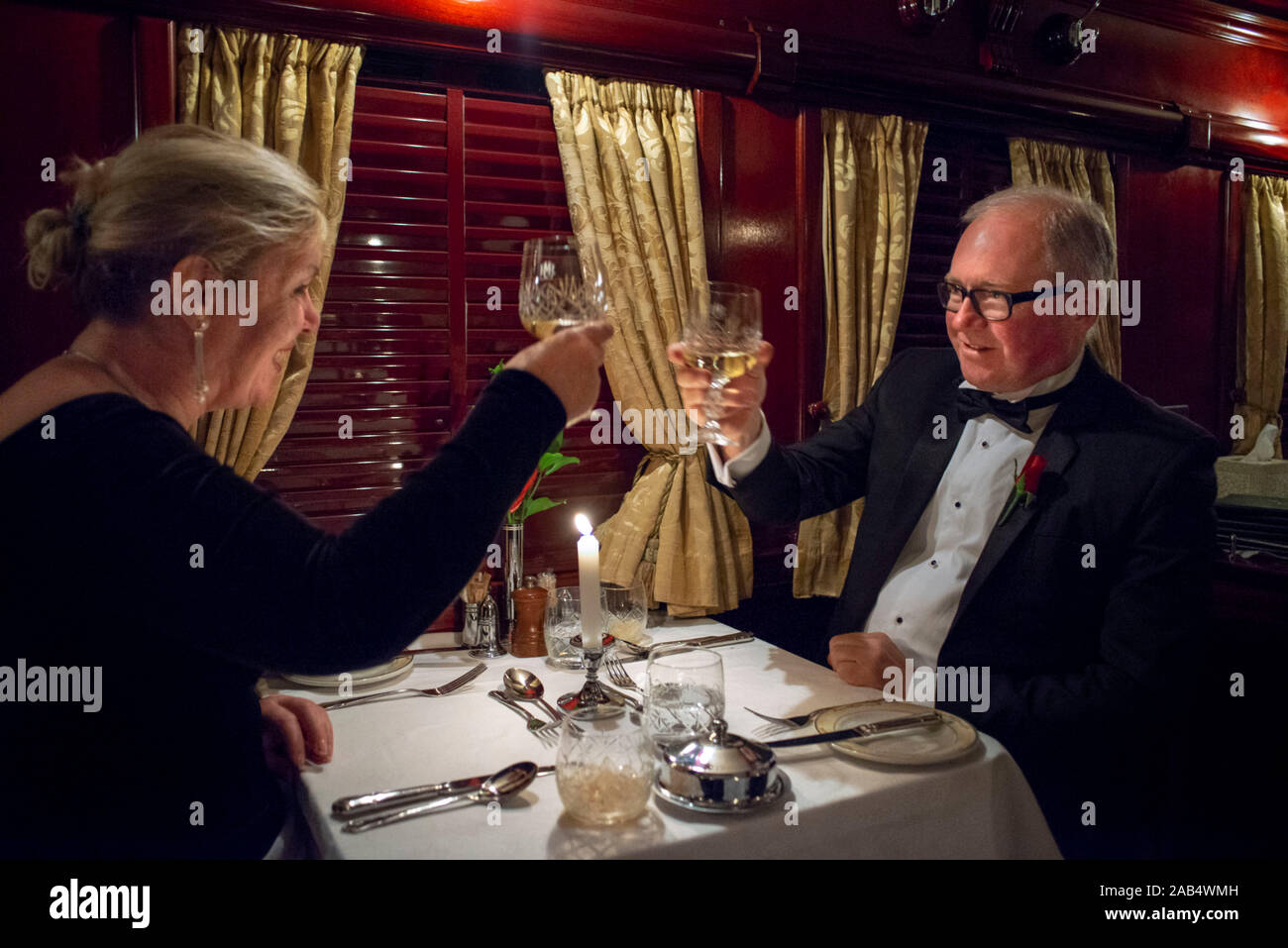 Passengers having dinner in the restaurant car of the The Rovos Rail luxury train travelling between Cape Town and Pretoria in South Africa  Pride of Stock Photo