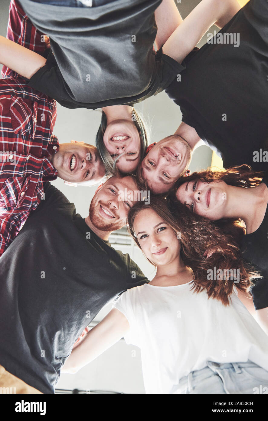 A large group of smiling friends hugging together. Stock Photo