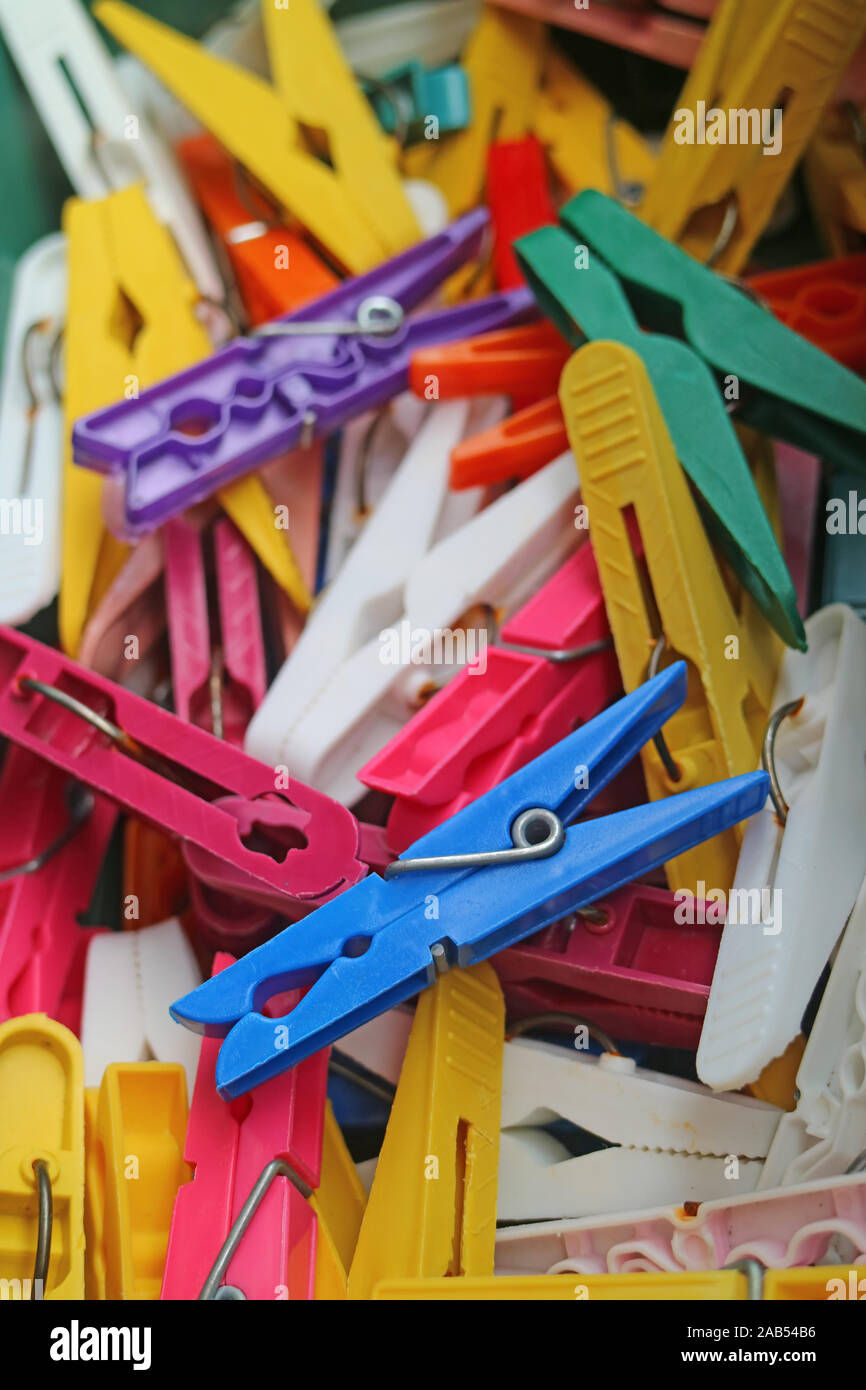 Pile of colorful clothes pegs with selective focus Stock Photo