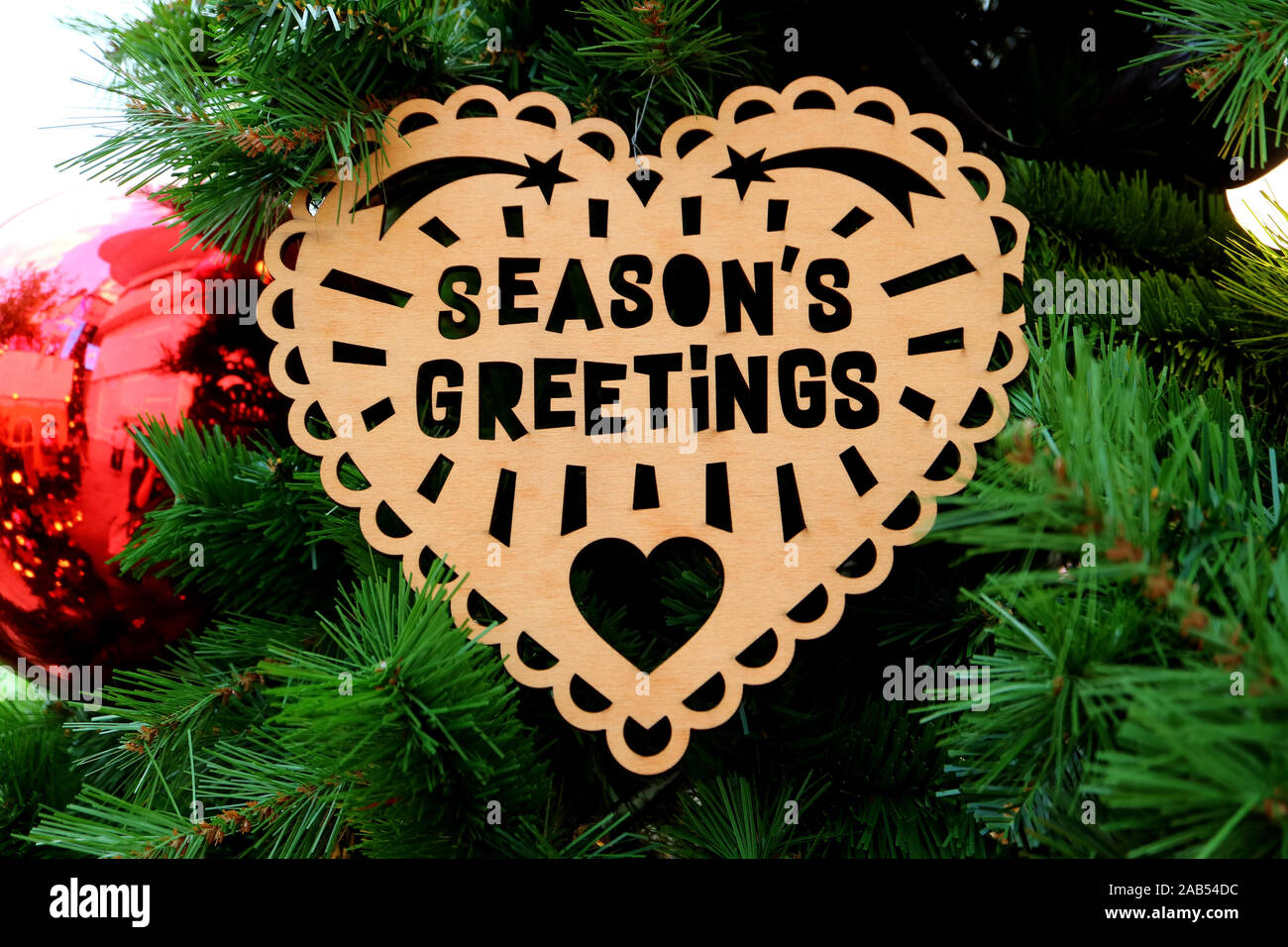 Wooden Heart Shaped Ornament With The Words Season S Greetings On