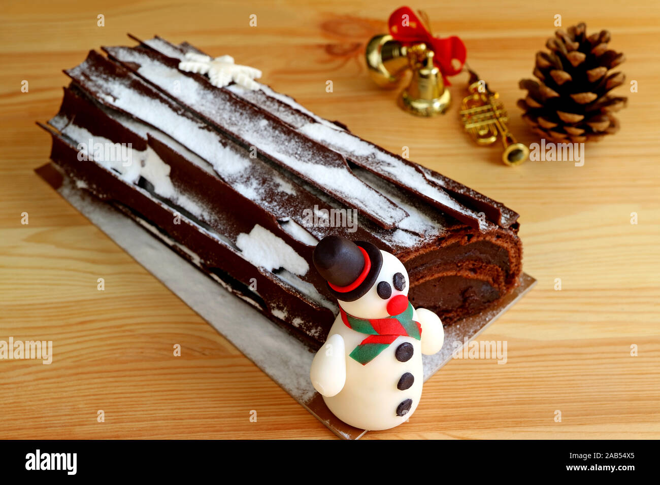 Three different patisserie Buches de Noel in dark and light chocolate  decorated with fruit and Christmas ornaments Stock Photo - Alamy