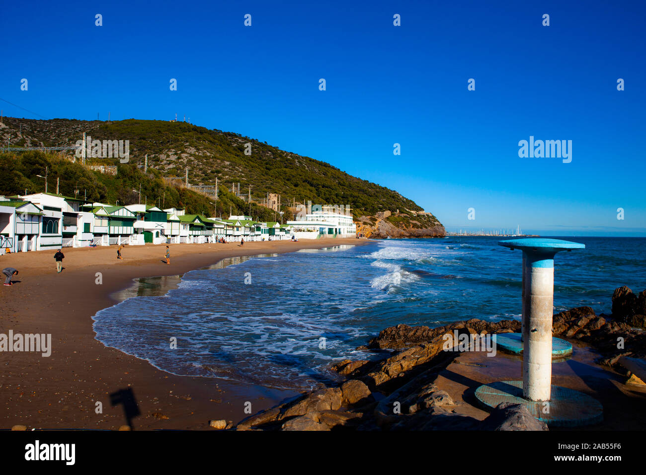 Platja de Les Casetes del Garraf, Garraf, Barcelona, Catalonia. These distinctive small green and white beach houses are in the beach village of Garra Stock Photo