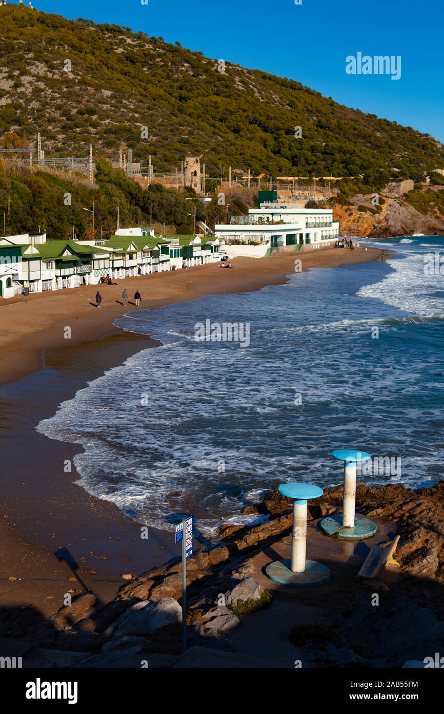 Platja de Les Casetes del Garraf, Garraf, Barcelona, Catalonia. These distinctive small green and white beach houses are in the beach village of Garra Stock Photo