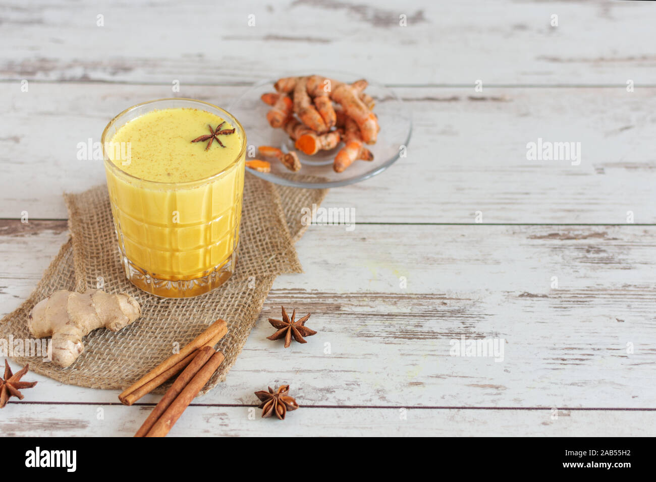 Golden turmeric milk with cinnamon and other aromatic spices. Healthy and aromatic detox beverage. Herbal medicine, anti-inflammatory therapy. Indian Stock Photo