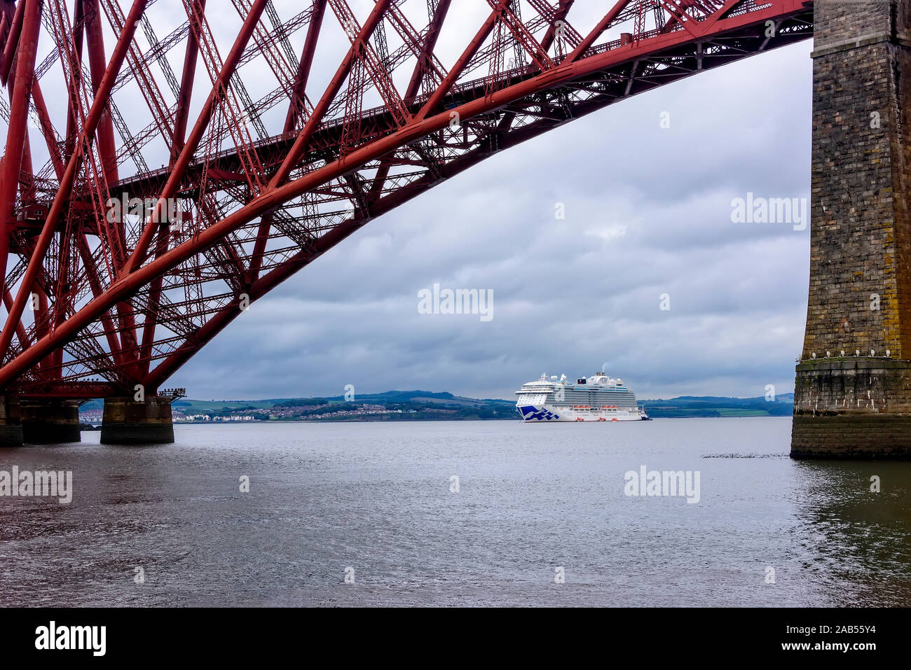 Edinburgh, Scotland - August 13, 2018:  Princess cruise ship, the Royal Princess, anchored in the Firth of Forth with the Forth Bridge overhead. Stock Photo