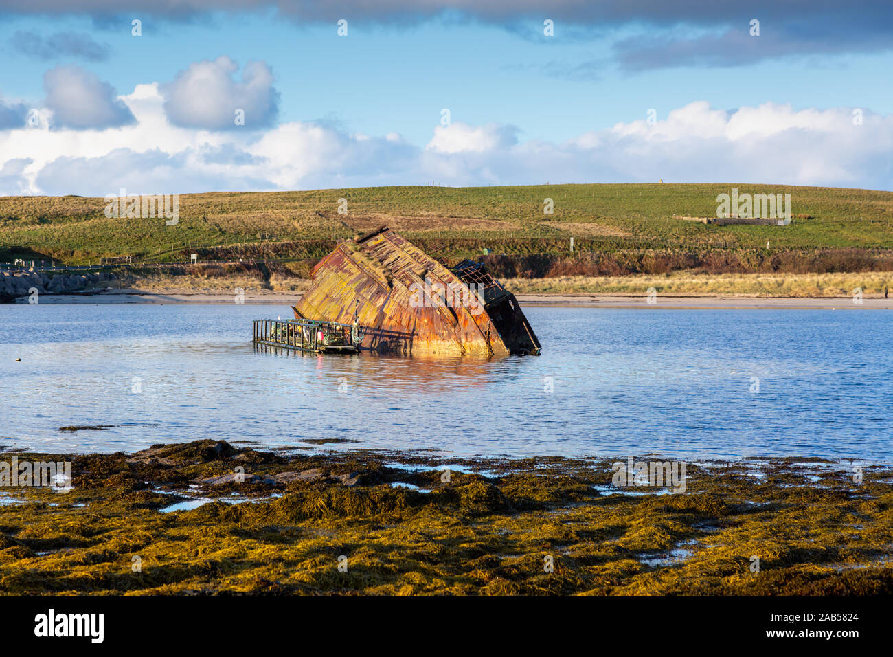 Rusting ship hull in the sea, Churchill Barriers, Orkney, UK Stock Photo