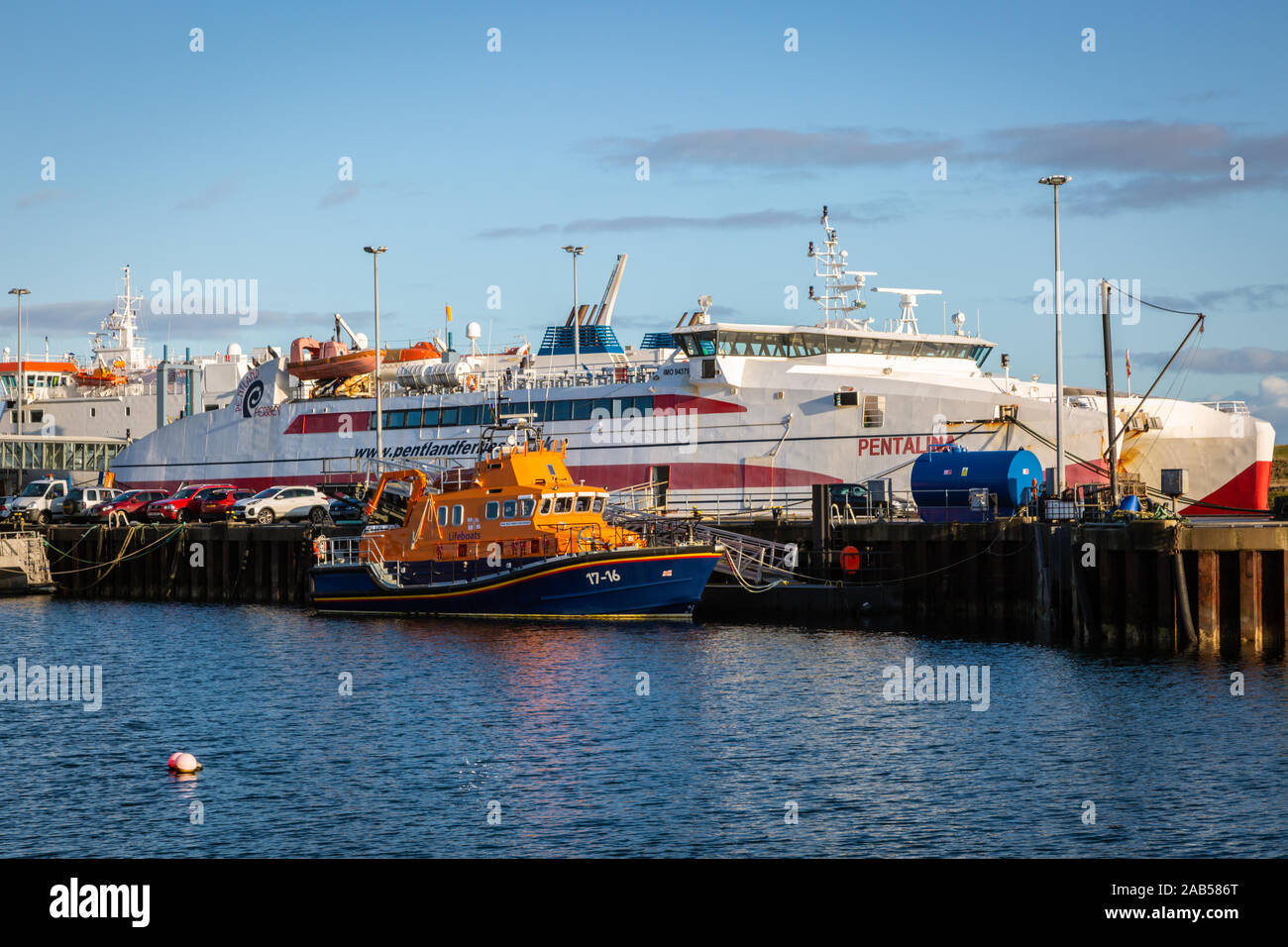 RNLI boat and ferry ship, Stromness harbour, Orkney, UK Stock Photo