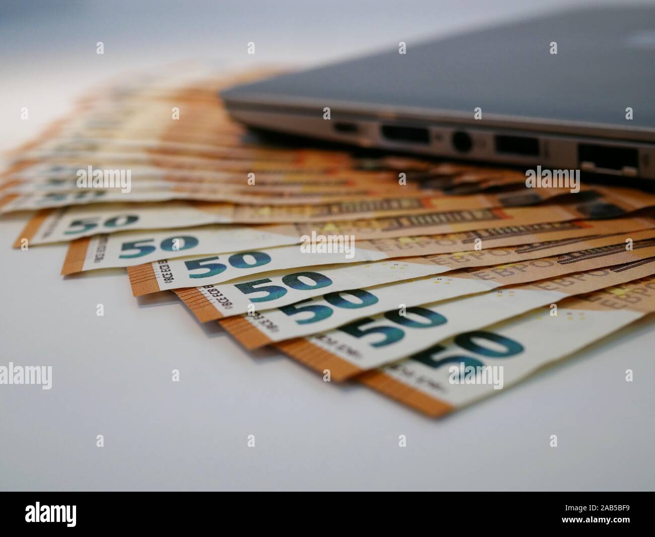 Euro cash money and computer concept Stock Photo - Alamy