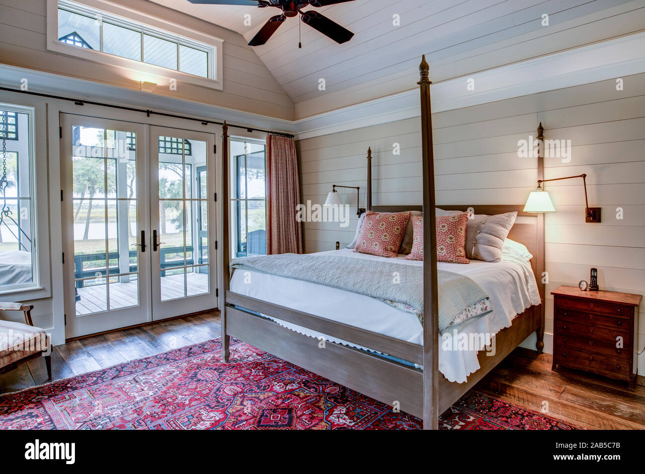 Beautiful luxury bedroom with view out onto waterfront and river. Stock Photo