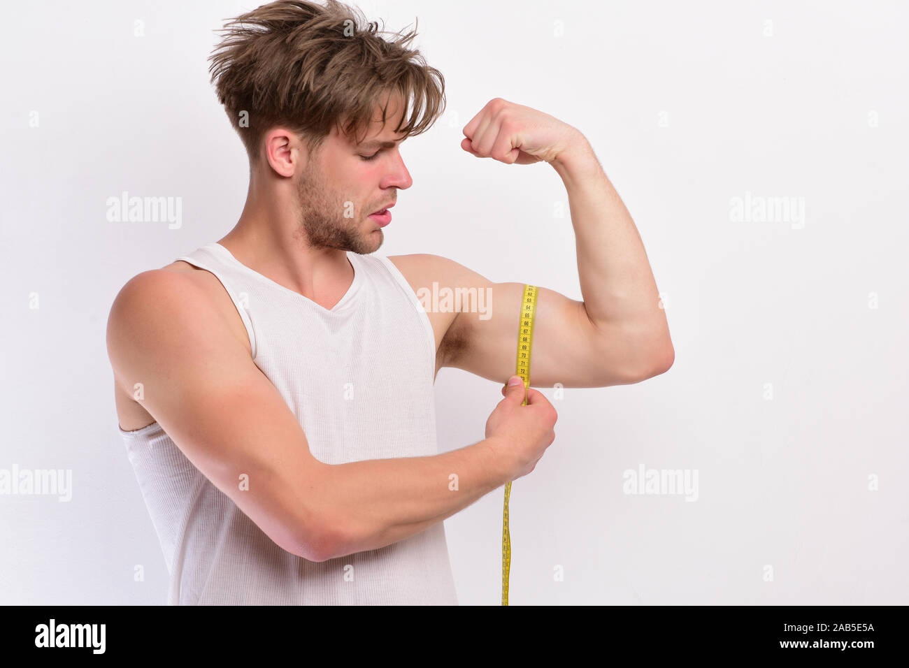 Happy Muscular Man Measuring Bicep Stock Photo by ©AndreyPopov 97125074