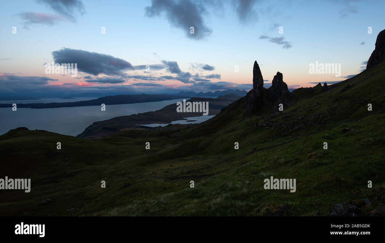 Old man of Storr photographed at blue hour.Silhouetted rock pinnacle and orange afterglow on cloudy sky.Breathtaking scenery on Isle of Skye,Scotland. Stock Photo