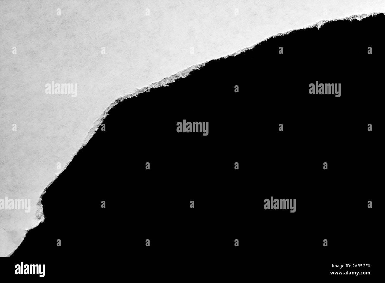 White paper with torn edges with a black isolated background inside ...