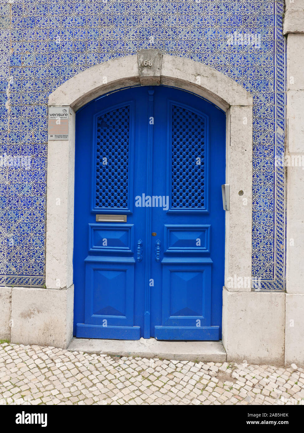 Blue door way surrounded by decorative blue tiles in the central area of the old town in Lisbon Portugal Stock Photo