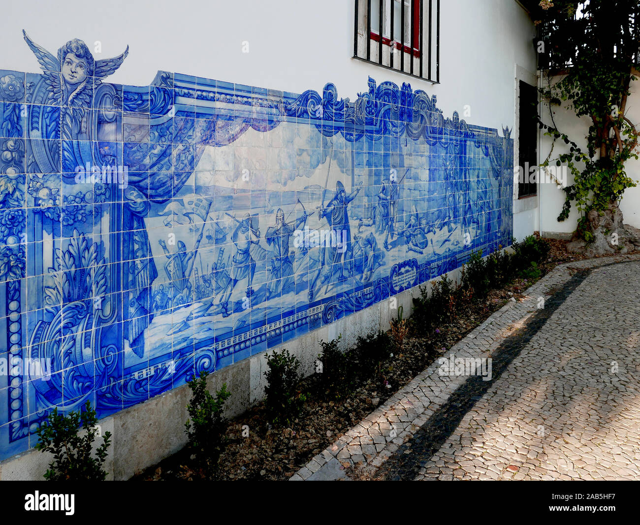 Blue and white ceramic tile mural on the Church of Sante Luzia in Lisbon, Portugal depicting a battle scene of the fall of Lisbon Stock Photo