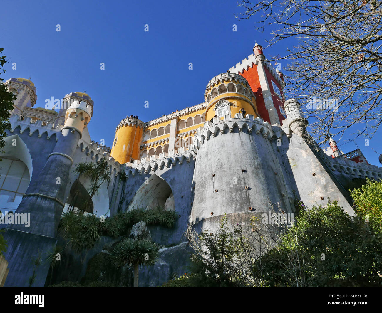 Looking upward toward one side of the castle at Sintra near Lisbon in Portugal known as the Pena Palace in São Pedro de Penaferrim Stock Photo