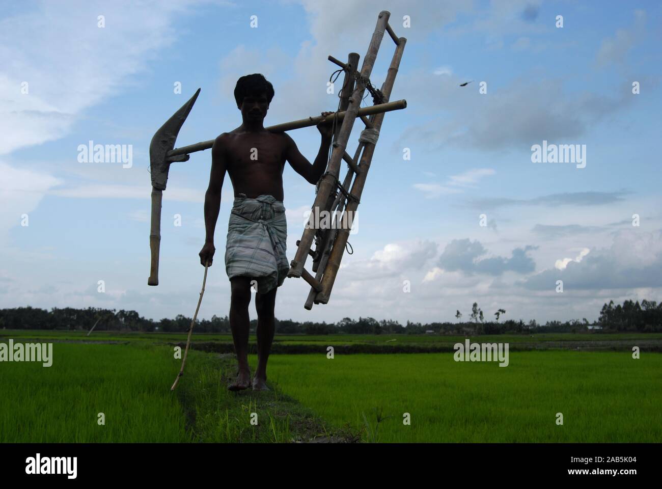 A farmer with traditional agricultural tools in a village of Bangladesh