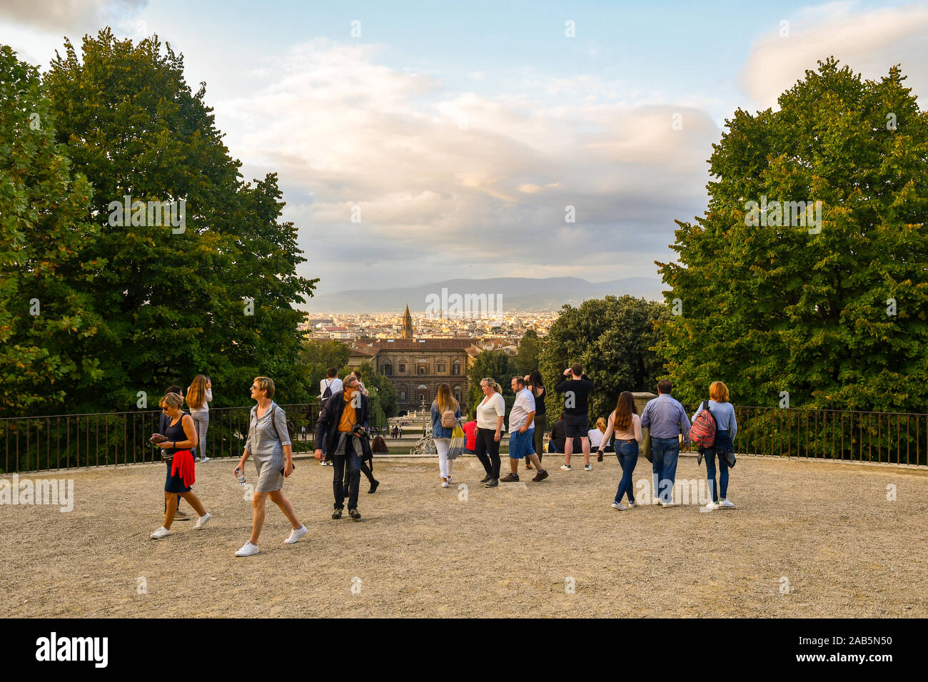 Tourists walking and admiring the cityscape from the Boboli Gardens of Palazzo Pitti in the historic centre of Florence, Tuscany, Italy Stock Photo